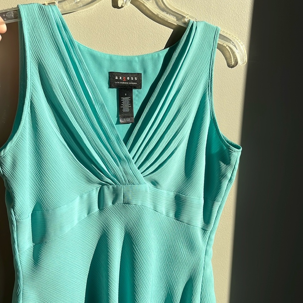 Sleeveless top in a light green teal color.